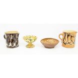 A collection of slipware pottery to include: two large jugs decorated with marble pattern; a small