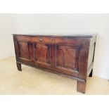 A Georgian oak blanket chest with three panels to the front and large original brass key