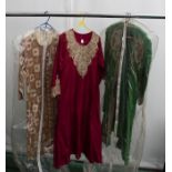 A burgundy silk Asian/Kaftan gown in silk/white gold embossed decoration on the yoke and front. A