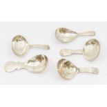 A group of five late 18th/ early 19th Century silver caddy spoons, all hallmarked to include: 1.