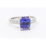 A tanzanite and diamond 18ct white gold ring, comprising a cushion cut tanzanite measuring approx