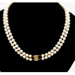 A double strand cultured pearl necklace uniform, each pearl approx 6mm  on a gilt metal clasp,