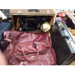 A mid 20th Century Singer sewing machine, in case, electric table top, along with briefcase and
