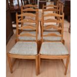 A set of six Ercol chairs, including two carvers, along with a small tripod table