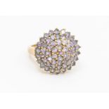 A stone set 9ct gold ring, comprising a round cut stones possibly tanzanite, setting approx 27mm,