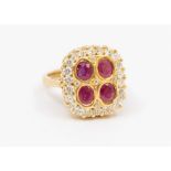 An 18ct gold ruby and white stone square cluster ring, the four oval-cut rubies surrounded by