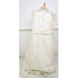 A 1980's wedding dress designed by Gina Fratini, the dress is in raw silk with leg, O Mutton