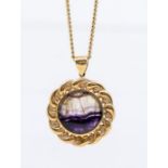 A Blue John and 9ct gold pendant, comprising a round rub- over set stone within a fancy border,