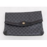 A black coated canvas Gucci bag patterned with the GG logo. On the front it has the GG gold metal