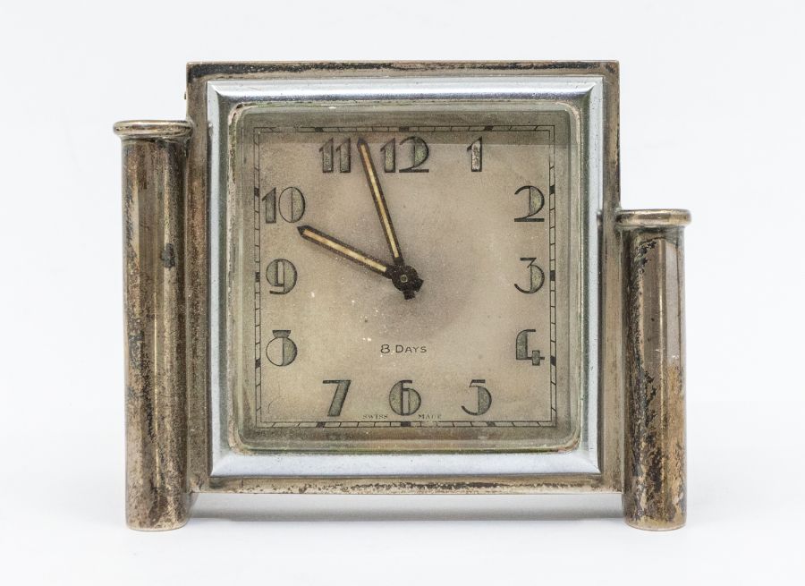 An Art Deco silver mounted 8 day desk clock, with luminous Arabic numbers and hands, plain square
