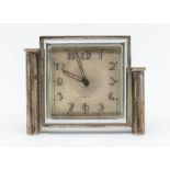 An Art Deco silver mounted 8 day desk clock, with luminous Arabic numbers and hands, plain square