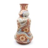 A Japanese baluster vase, red ironstone decorated with flowers and dragon with relief scale work,