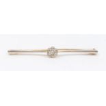 An Edwardian diamond and 14ct gold bar brooch, comprising a central diamond set flower cluster,