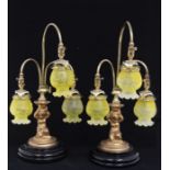 A pair of Victorian style gilt metal three light table lamps, curved stems with etched yellow