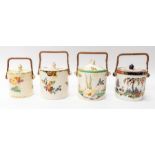 Collection of four mixed pattern, early 20th century, Losol ware biscuit barrels with cane handles