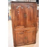 George III mahogany floor standing double corner cupboard in one unit four panelled opening doors to