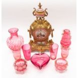 Nine pieces of cranberry glass and French gilt, with a porcelain mantle clock (10)