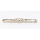 An Edwardian diamond set filigree bar brooch, comprising a central old cut diamond weighing approx