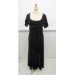 An iconic Caroline Charles long evening dress, with an empire line bodice edged in scrolled braid,