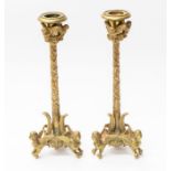 A Grand Tour pair of cast metal candlesticks, modelled with winged ladies and owls