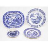 A collection of blue and white Willow pattern kitchen and dinner wares including large meat plates