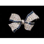 A sapphire and diamond 18ct white gold bow brooch comprising a ground of round brilliant cut pave