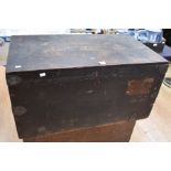 An early 20th Century black travel trunk with metal edges and carry handles