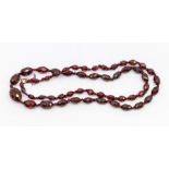 A faceted cherry Bakelite type necklace, comprising graduated oval and marquise shaped beads, length
