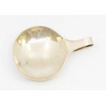 A George V large plain oval shaped caddy spoon with turn over handle, hallmarked by Roberts &