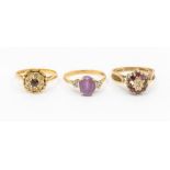 Three gem set 9ct gold rings to include a ruby and diamond cluster, size O, an amethyst and