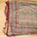 A very large crepe de chine paisley shawl, 1860's with fine silk burgundy tassels, the colourway