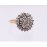 A diamond and 18ct gold cluster ring, the centre set with a flower cluster of round brilliant cut