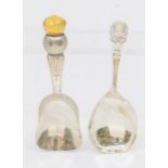 An Arts & Crafts silver thistle shaped caddy spoon, the handle with bright-cut decoration