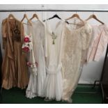 A pale pink slub silk sunt with a peplum jacket A cream satin wedding dress with a ruched design