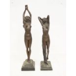 Two bronzed figures of naked ladies on stands