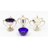 An Edwardian silver matched three piece condiment set comprising: salt, mustard pot and cover with