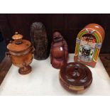 Collection of treen items including juice box cookie jar, buddha and figure, turned lidded bowl.