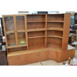 A 1970's GPlan teak living room display unit with part glazed doors, open shelving, curved end