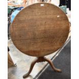 A George III oak snap top supper table, the circular dished table on ovoid central support and 3