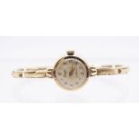 A ladies 9ct gold vintage Accurist wristwatch, round champagne dial with applied gold tone number