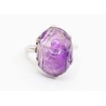An amethyst and 18ct white gold ring, comprising a carved amethyst in the form of a scarab beetle,