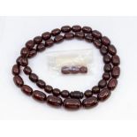 A cherry amber type bead necklace, comprising ovoid beads from 13 x 11mm to 28 x 17mm, length approx