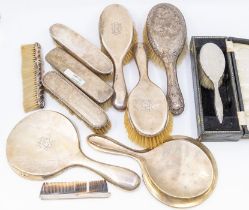 A collection of silver mounted dressing table items including hand and hair brushes, comb, mirror,