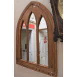 A mahogany wall mirror in the style of a church window