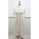 A cotton lawn, Mid Edwardian, white broderie Anglais dress, the hemline has a wide hemline in lace