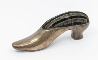 A late Victorian large novelty silver hat pin cushion, cast in the form of a shoe, plain body, the