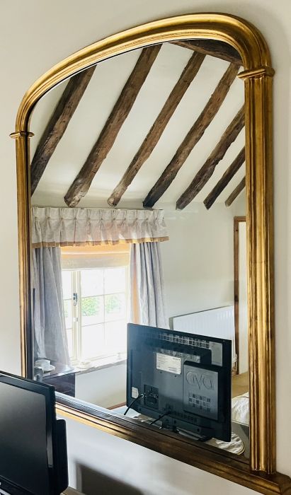 A 20th century gilt arch shaped mirror. ***Offsite Location***