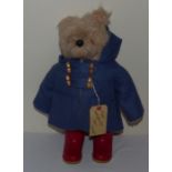 An early Paddington Bear with blue coat and red Dunlop boots , his duffle coat does have some moth