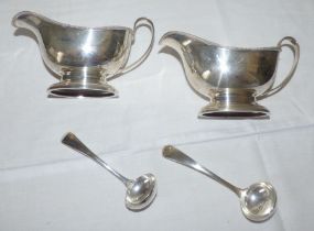 A pair of Georgian style silver sauceboats with beaded border, scroll handle, oval bases,