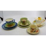 A group of teawares to include a Clarice Cliff trio decorated with handpainted flowers on the